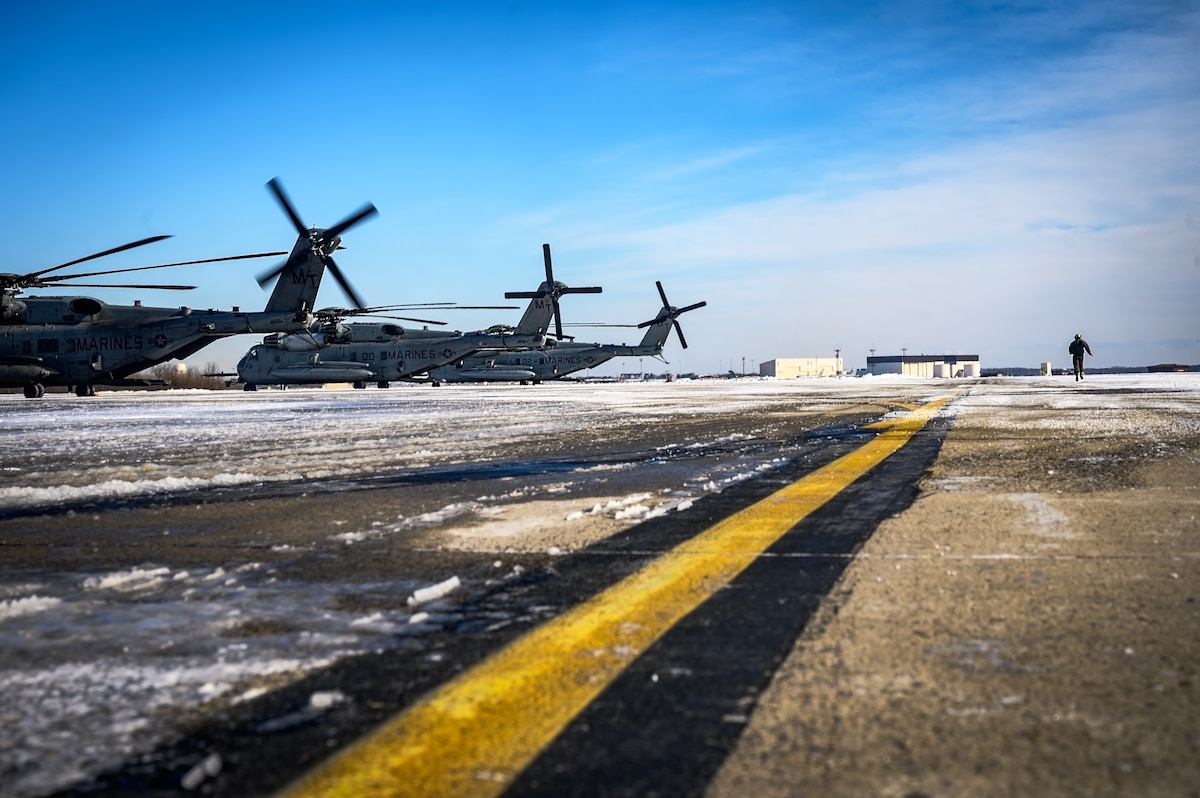 U.S. Marine Corps Cpl. Juan Estrada, Marine HMH Squadron 772 helicopter crew chief, surveys a CH-53E Super Stallion helicopter prior to takeoff at Joint Base McGuire-Dix-Lakehurst, N.J., Jan. 22, 2025. The helicopter was requested on behalf of the Pennsylvania Army National Guard to lift and relocate nine Stryker armored vehicles to the Fort Indiantown Gap training range. The lift was assisted by a team of U.S. Air Force Airmen assigned to the 621st Contingency Response Group who secured and released each Stryker to the helicopter. (U.S. Air Force photo by Senior Airman Matt Porter)