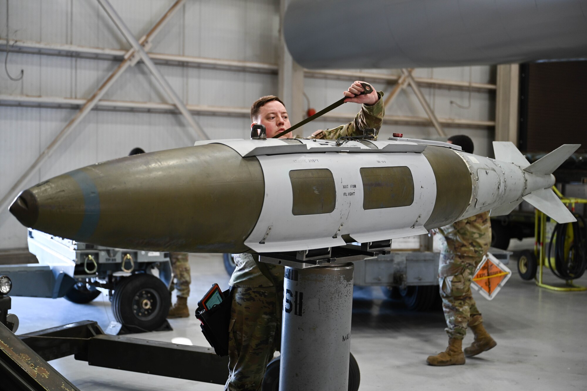 U.S. Air Force Staff Sergeant Christopher Wegmann, 9th Bomber Generation Squadron load crew team chief, prepares to load a guided bomb unit, during the Lone Star Challenge, at Dyess Air Force Base, Texas, Jan. 24, 2025. During the annual loading competition, two teams competed to honor the Wing’s best load crew of the year, showcasing their skills for potential real-world scenarios. (U.S. Air Force photo by Airman Caleb Schellenberg)