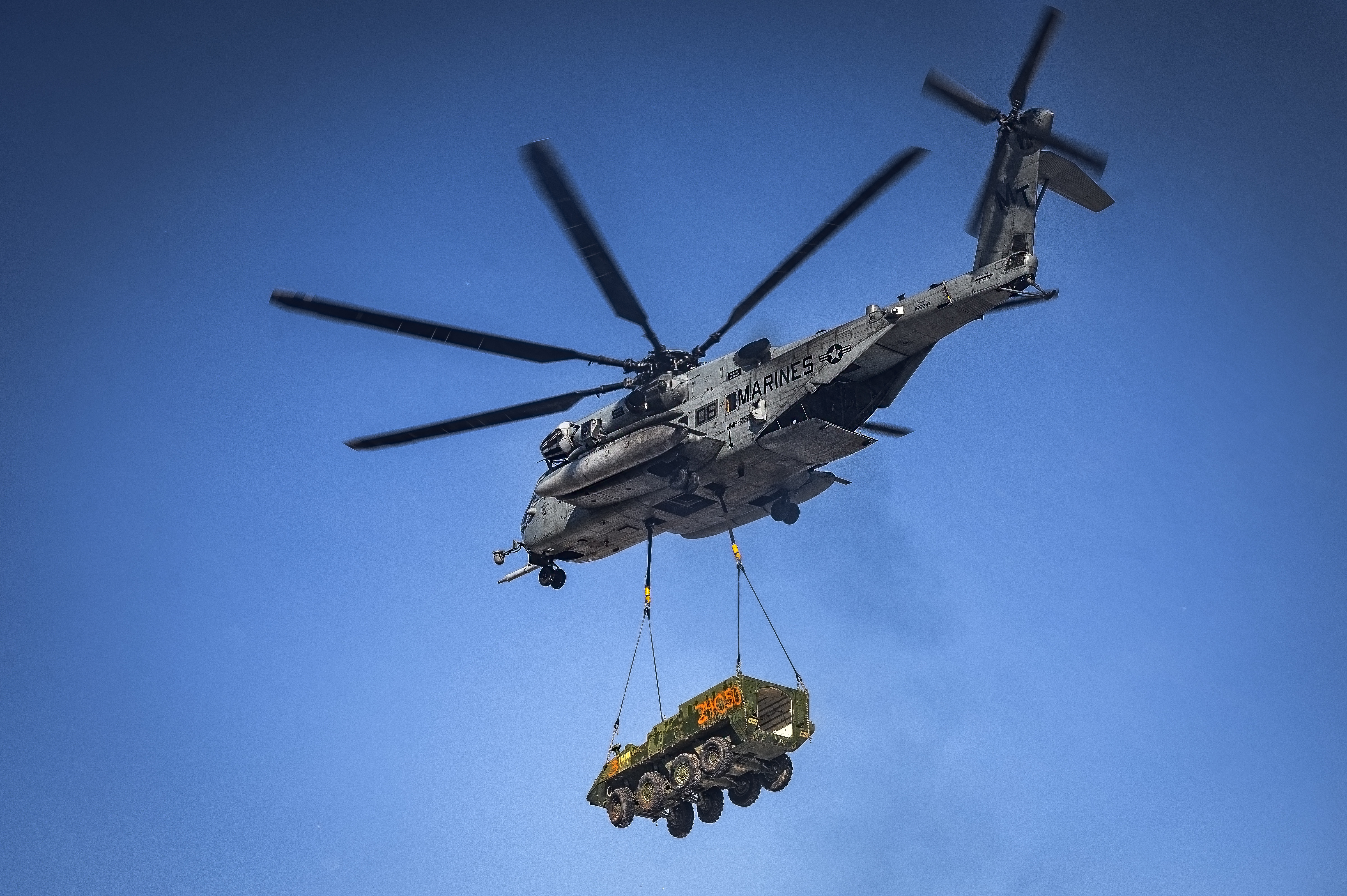 A CH-53E Super Stallion helicopter assigned to Marine Heavy Helicopter Squadron 772 relocates a Stryker armored vehicle at Fort Indiantown Gap, P.A., Jan. 22, 2025. The helicopter was requested on behalf of the Pennsylvania Army National Guard to lift and relocate nine Stryker armored vehicles to the Fort Indiantown Gap training range. The lift was assisted by a team of U.S. Air Force Airmen assigned to the 621st Contingency Response Group who secured and released each Stryker to the helicopter. (U.S. Air Force photo by Senior Airman Matt Porter)