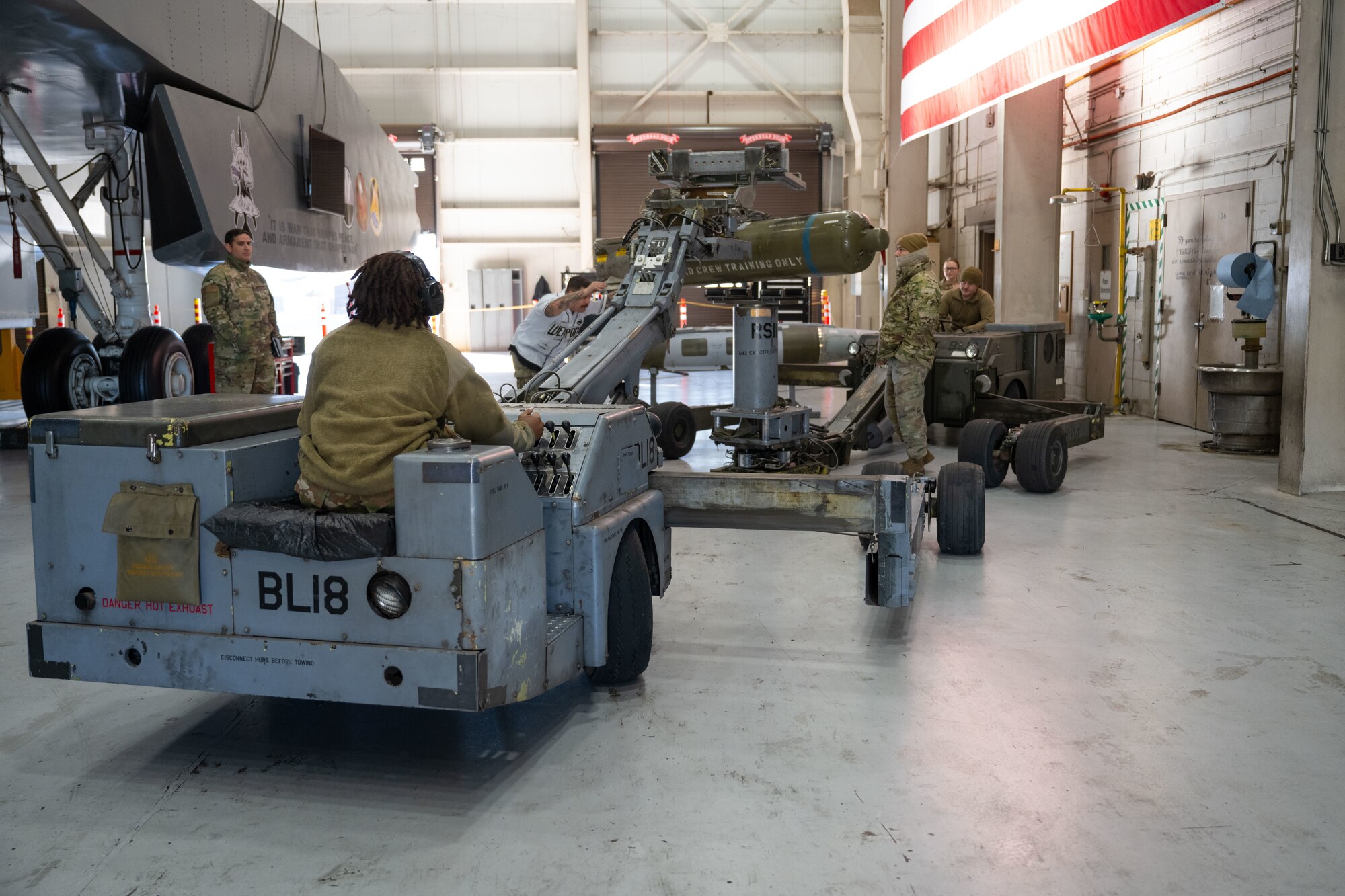 U.S. Air Force 28th Bomber Generation Squadron load crew members prepare to load a cluster bomb unit, during the Lone Star Challenge, at Dyess Air Force Base, Texas, Jan. 24, 2025. Each BGS hand-selected a crew to compete against each other; the winner of the challenge will compete against other bases within Air Force Global Strike Command. (U.S. Air Force photo by Senior Airman Emma Anderson)