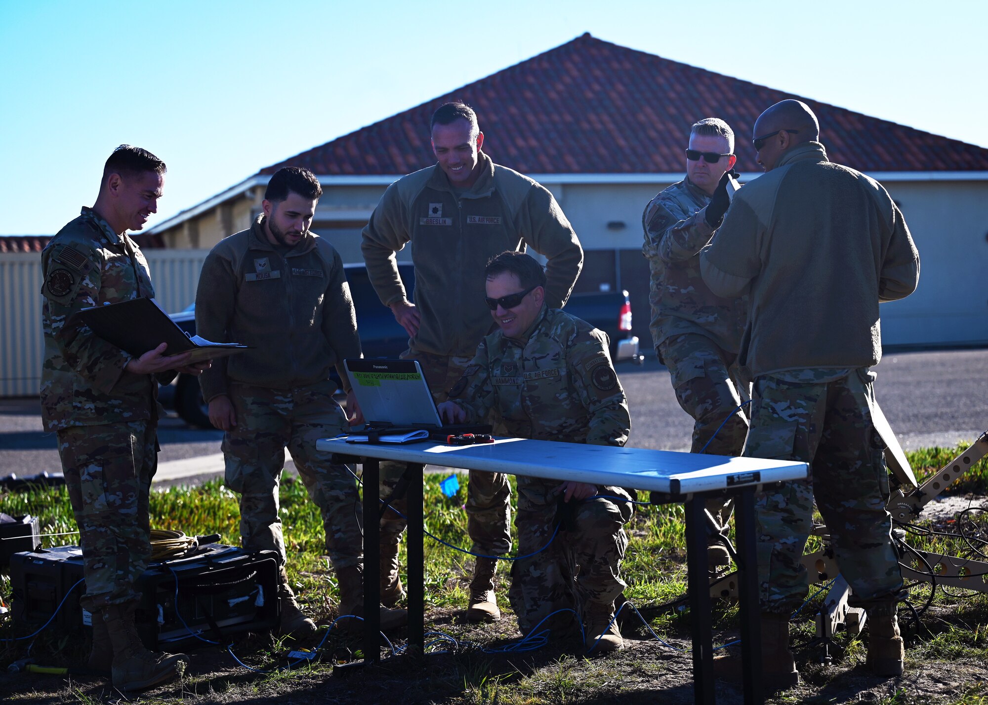 Participants from the 147th Combat Communications Squadron and the 216th Electromagnetic Warfare Squadron conduct equipment setup.