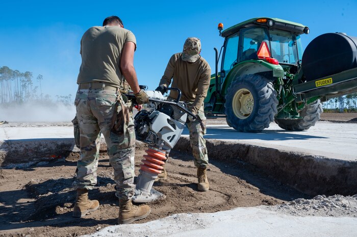 U.S. Airmen assigned to the 11th Air Task Force use a jumping jack on a damaged section of the flight line at Tyndall Air Force Base, Florida, Jan. 26, 2025. The jack was used to compact the dirt before the Airmen added a protective layer. (U.S. Air Force photo by Senior Airman Jasmyne Bridgers-Matos)