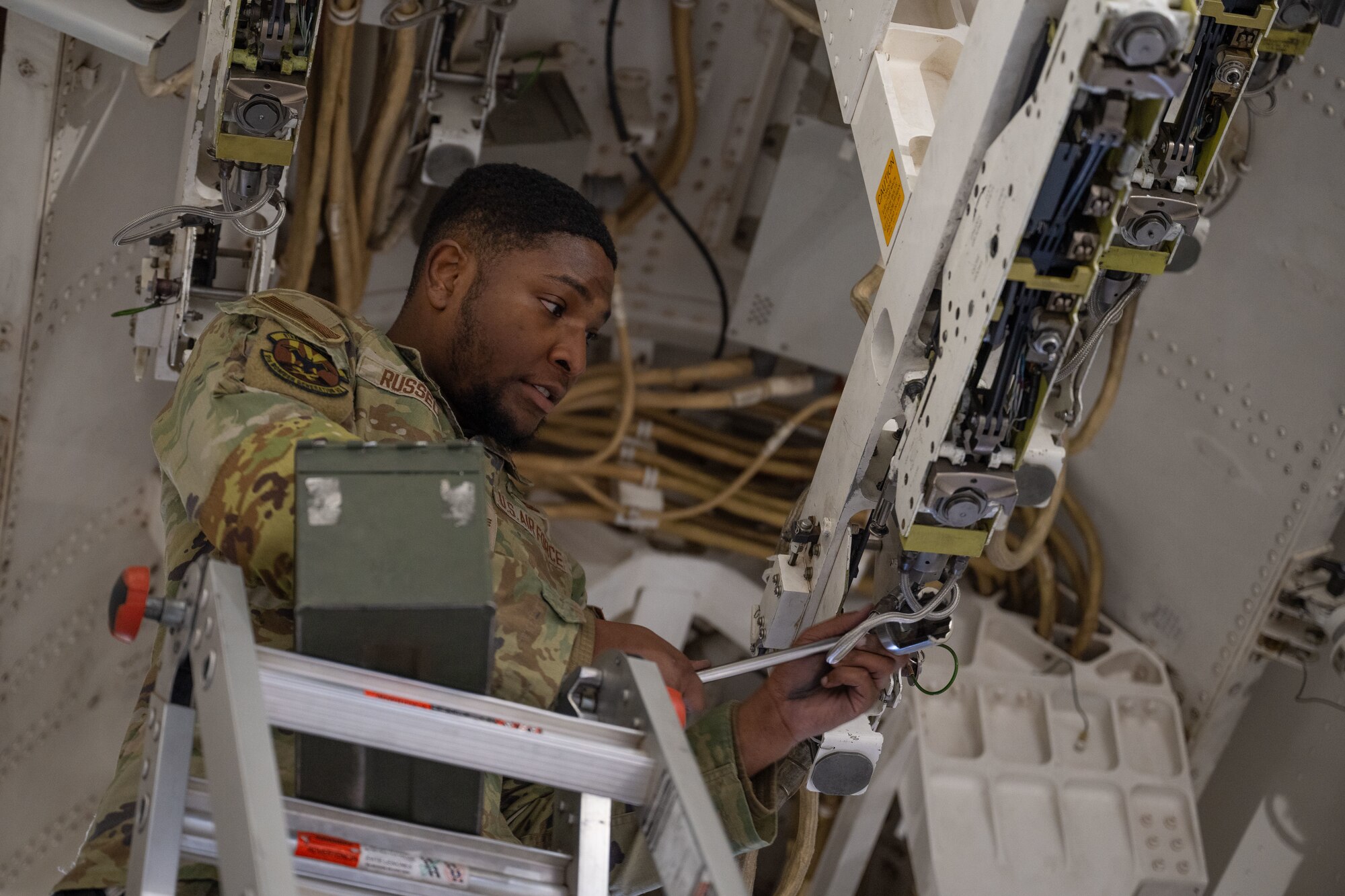 U.S. Air Force Senior Airman Davian Russell, 9th Bomber Generation Squadron load crew member, prepares to load a munition, during the Lone Star Challenge, at Dyess Air Force Base, Texas, Jan. 24, 2025. The challenge consisted of a written test, numerous inspections, and a loading evaluation from weapons standardization. (U.S. Air Force photo by Senior Airman Emma Anderson)