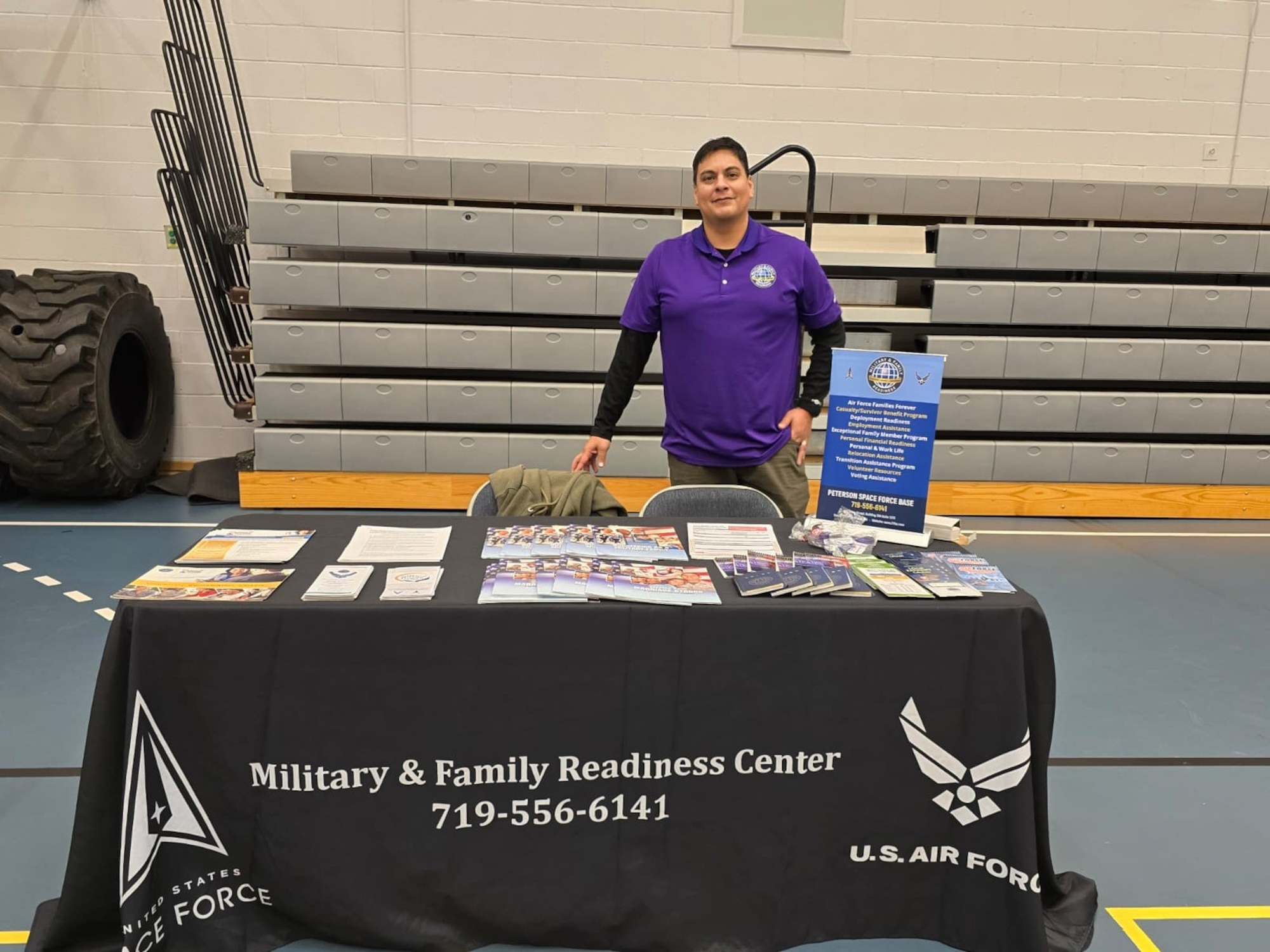 Service member stands behind his desk at the resilience fair.
