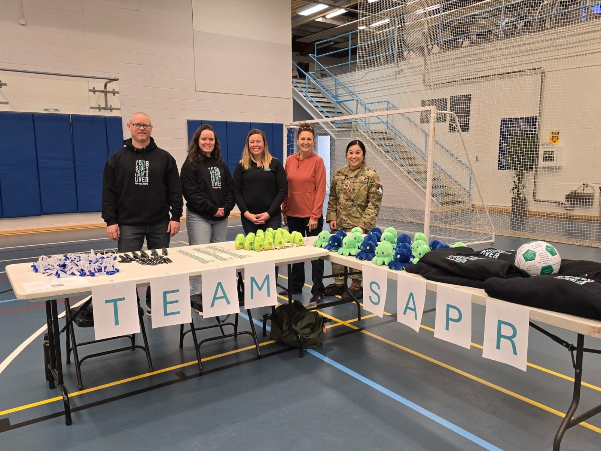 Member stand behind their desk at the resilience fair.