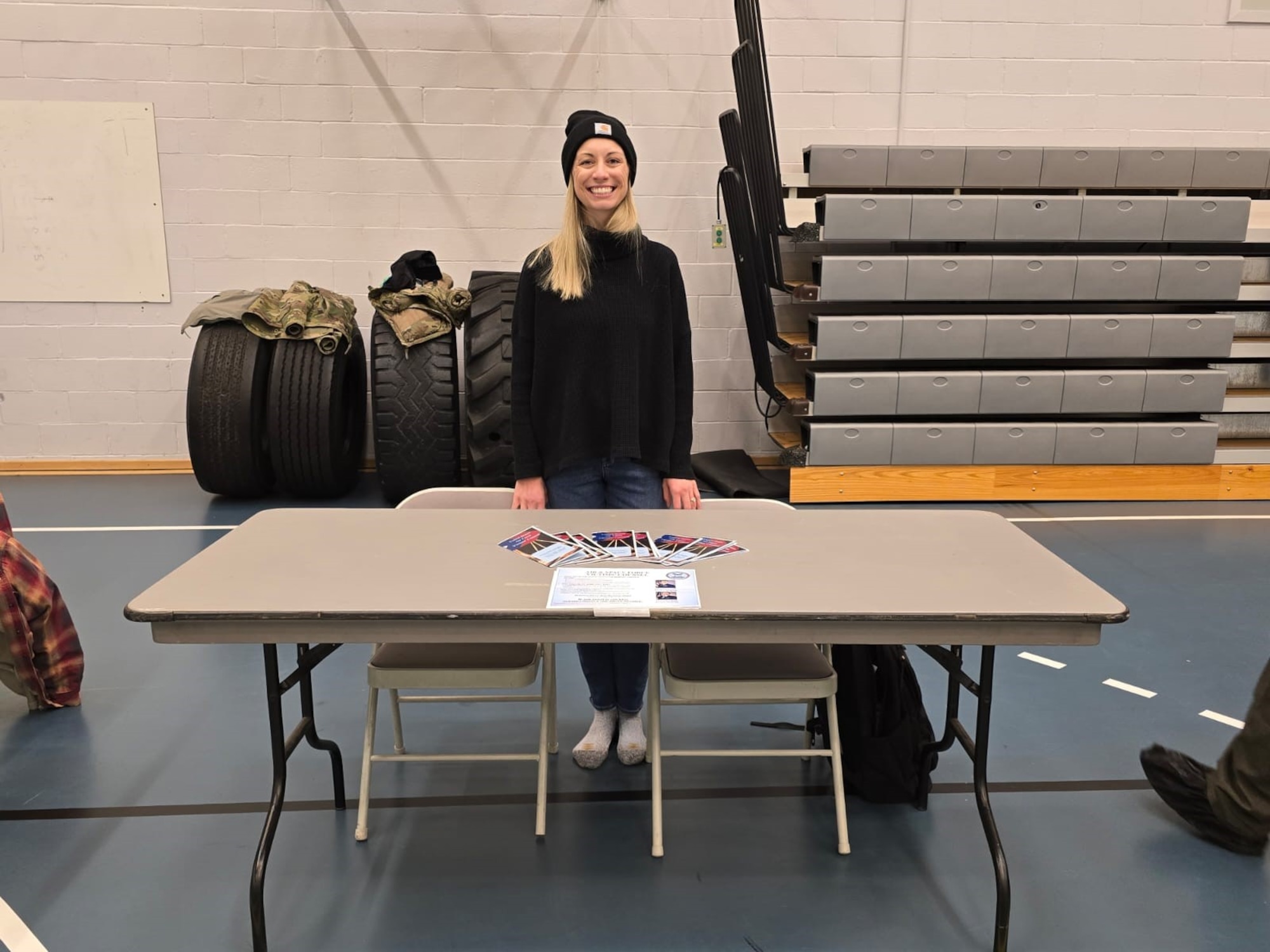 The member stands behind her desk for a photo at the resilience fair.