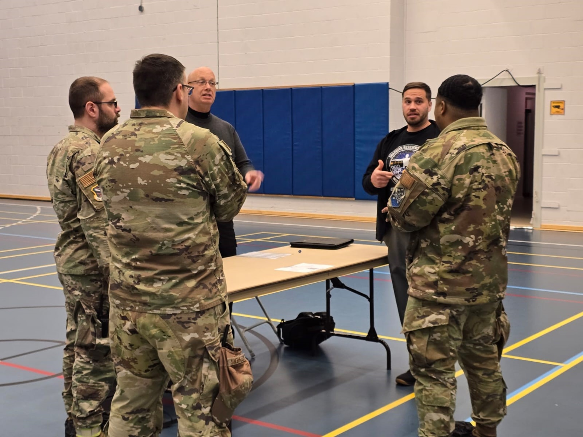 The GRT team standing with servicemembers talking