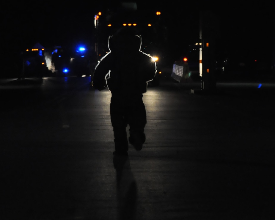 A member of EOD Mobile Unit 12 Dahlgren Detachment runs toward a simulated VBIED during a training exercise at NSF Dahlgren, Va.