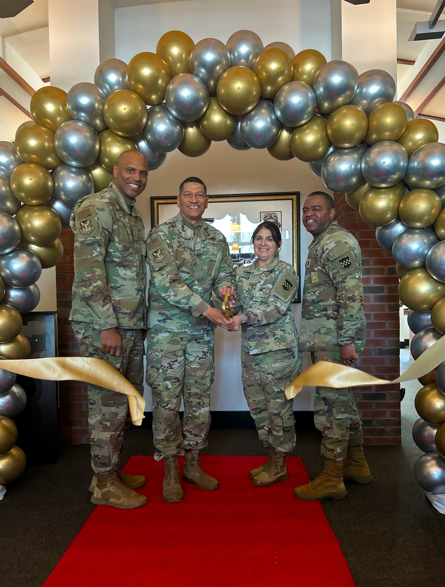 (Left to right) U.S. Air Force Chief Master Sgt. Michael Wynne, 87th Air Base Wing command chief, Col. Anthony Smith, Joint Base McGuire-Dix-Lakehurst and 87th Air Base Wing commander, Maj. Gen. Kris Belanger, 99th Readiness Division commanding general and Command Sgt. Maj.  Corey Thompson, 99th Readiness Division command sergeant major, cut the ribbon officially opening the new location for Pudgy’s Sport Pub at JB MDL, N.J., Jan. 24, 2025. The original Pudgy’s, lovingly named for U.S. Air Force Maj. Thomas McGuire’s wife, Marilynn, opened on McGuire Air Force Base Sep. 27,1996. (U.S. Air Force photo by Jewaun McElroy)