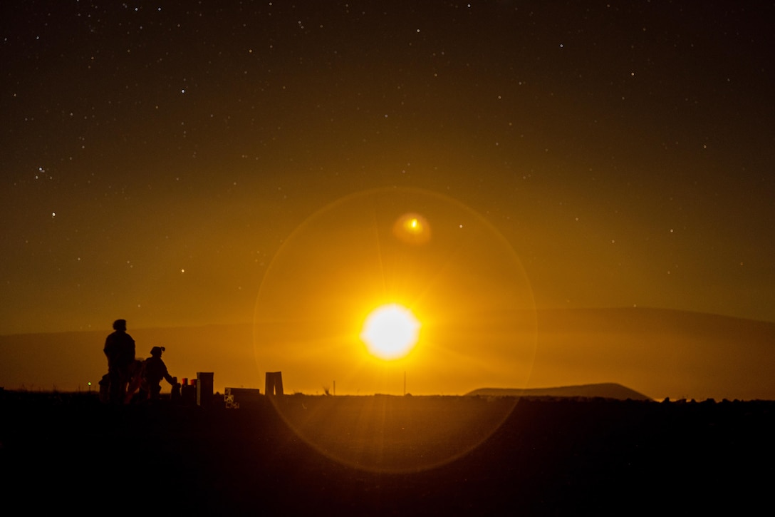 Marines observe an M853A1 illumination round during a training exercise at Pohakuloa Training Area, Hawaii, Jan. 17, 2025.