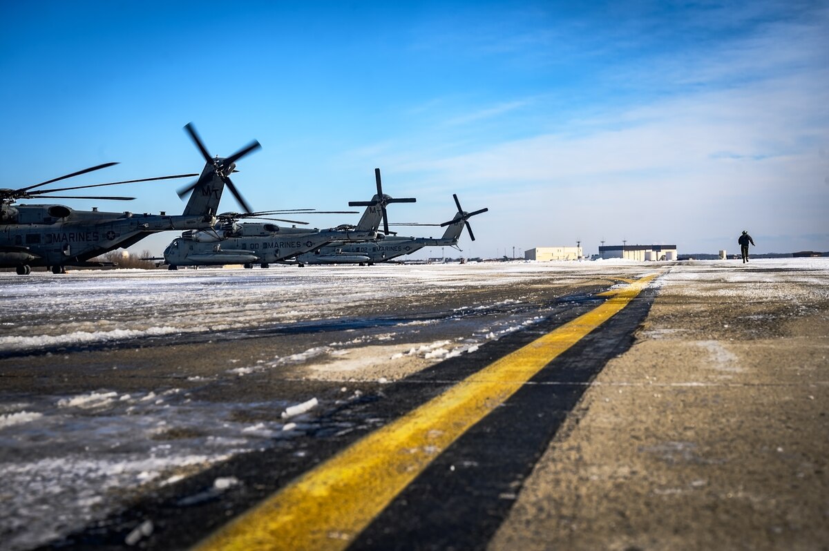 U.S. Marine Corps Cpl. Juan Estrada, Marine HMH Squadron 772 helicopter crew chief, surveys a CH-53E Super Stallion helicopter prior to takeoff at Joint Base McGuire-Dix-Lakehurst, N.J., Jan. 22, 2025. The helicopter was requested on behalf of the Pennsylvania Army National Guard to lift and relocate nine Stryker armored vehicles to the Fort Indiantown Gap training range. The lift was assisted by a team of U.S. Air Force Airmen assigned to the 621st Contingency Response Group who secured and released each Stryker to the helicopter. (U.S. Air Force photo by Senior Airman Matt Porter)