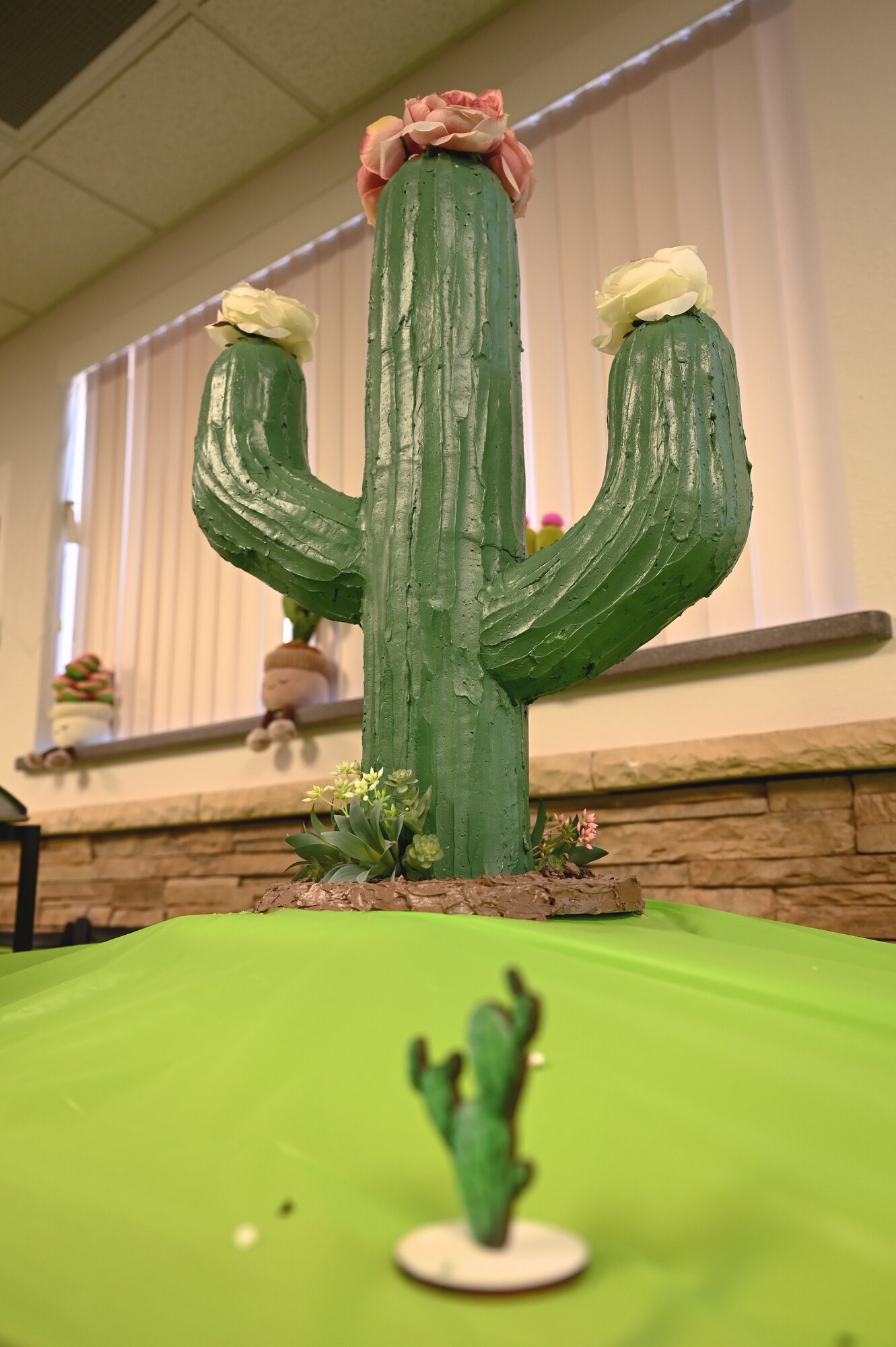 A cactus cake is displayed during the John L. Hennessy inspection at Davis-Monthan Air Force Base, Arizona, Jan. 26, 2025. The dining facility held a cactus-themed event to symbolize the heart and commitment of the DFAC team to the Desert Lightning community. (U.S. Air Force photo by Senior Airman Andrew Garavito)