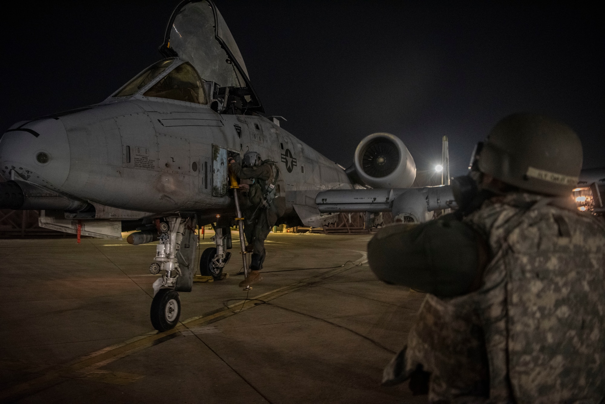 U.S. Air Force Capt. Eric Fox, 25th Fighter Squadron A-10 Thunderbolt II pilot, left, egresses from an A-10 during Beverly Herd 25-2 at Osan Air Base, Republic of Korea, Jan. 30, 2025. Aircrews exercised rapid crew swap, a process that allows the 25th FS to continuously generate combat airpower. (U.S. Air Force photo by Staff Sgt. Jason W. Cochran)