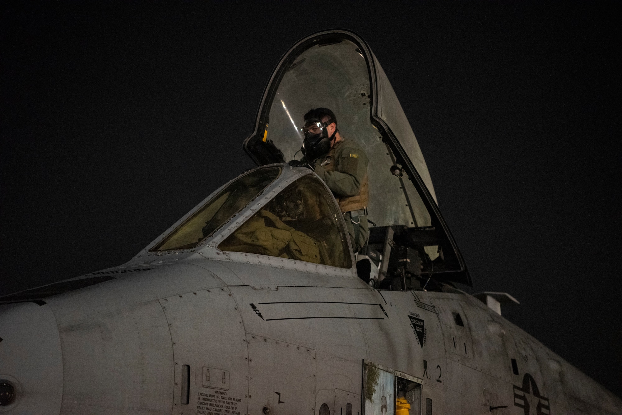 U.S. Air Force Capt. Chris Hidalgo, 25th Fighter Squadron A-10 Thunderbolt II pilot, enters the cockpit during Beverly Herd 25-2 at Osan Air Base, Republic of Korea, Jan. 30, 2025. Hidalgo exercised a rapid crew swap with simulated CBRN contamination as part of the exercise to continuously generate combat airpower. (U.S. Air Force photo by Staff Sgt. Jason W. Cochran)