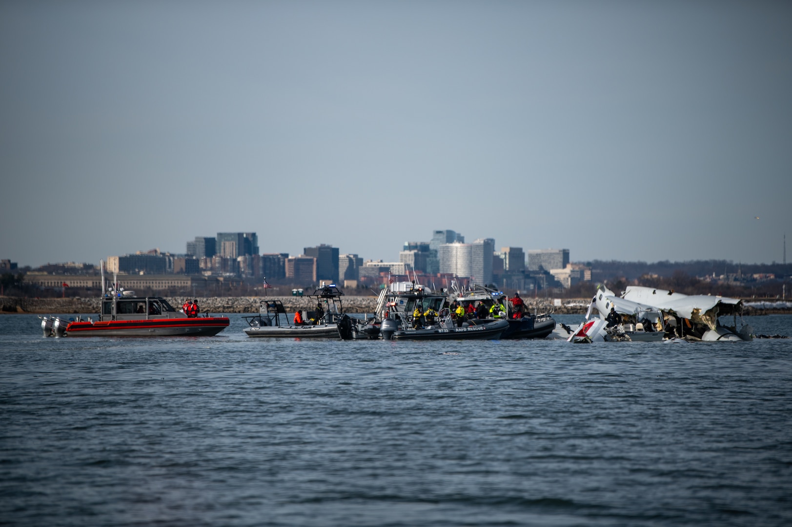 Response boat crews from Coast Guard stations Washington, Curtis Bay, Annapolis, Oxford, and Crisfield enforce a safety zone around the incident scene in the Potomac River, January 30, 2025.