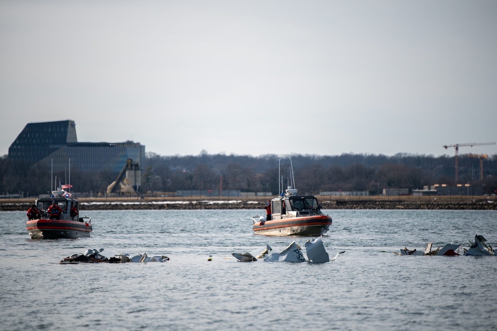 Response boat crews from Coast Guard stations Washington, Curtis Bay, Annapolis, Oxford, and Crisfield enforce a safety zone around the incident scene in the Potomac River, January 30, 2025.