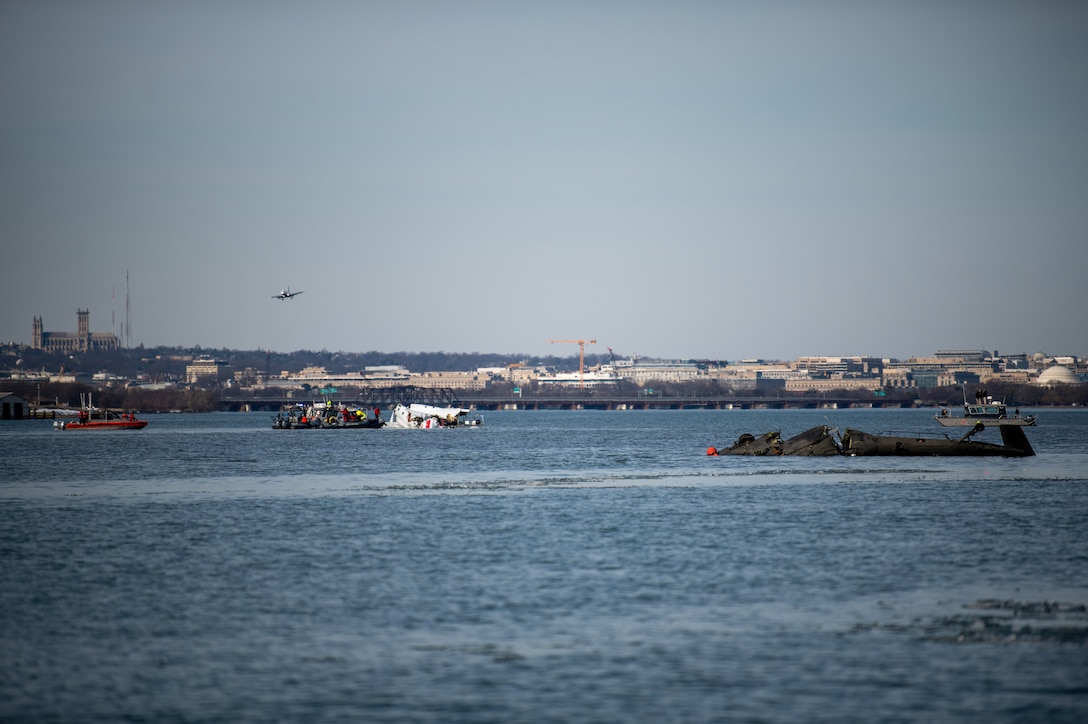 Response boat crews from Coast Guard stations Washington, Curtis Bay, Annapolis, Oxford, and Crisfield enforce a safety zone around the incident scene in the Potomac River, January 30, 2025.