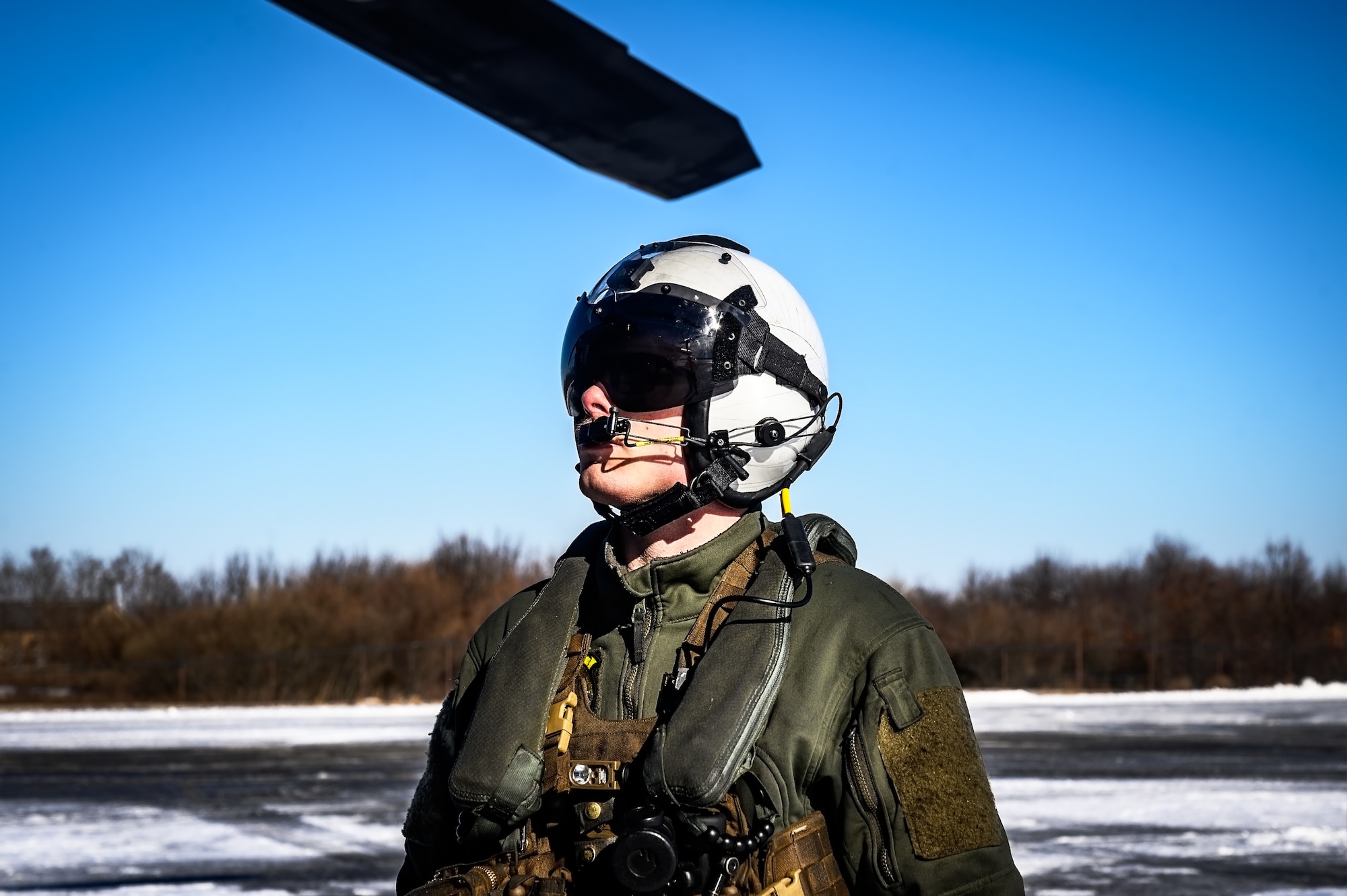 U.S. Marine Corps Sgt. Michael Karpinski, Marine Heavy Helicopter Squadron 772 helicopter crew chief, prepares a CH-53E Super Stallion helicopter for takeoff at Joint Base McGuire-Dix-Lakehurst, N.J., Jan. 22, 2025. The helicopter was requested on behalf of the Pennsylvania Army National Guard to lift and relocate nine Stryker armored vehicles to the Fort Indiantown Gap training range. The lift was assisted by a team of U.S. Air Force Airmen assigned to the 621st Contingency Response Group who secured and released each Stryker to the helicopter. (U.S. Air Force photo by Senior Airman Matt Porter)