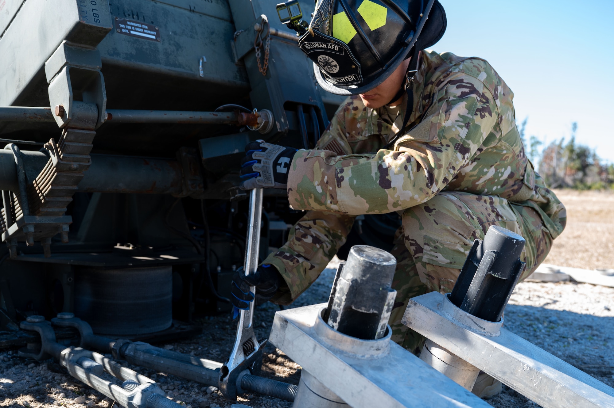 A U.S. Airman assigned to the 11th Air Task Force secures an aircraft arresting system to the bolting mechanism at Tyndall Air Force Base, Florida, Jan. 26, 2025. Aircraft arresting systems utilize a cable to ensure that aircraft are able to stop on the runway. (U.S. Air Force photo by Senior Airman Jasmyne Bridgers-Matos)