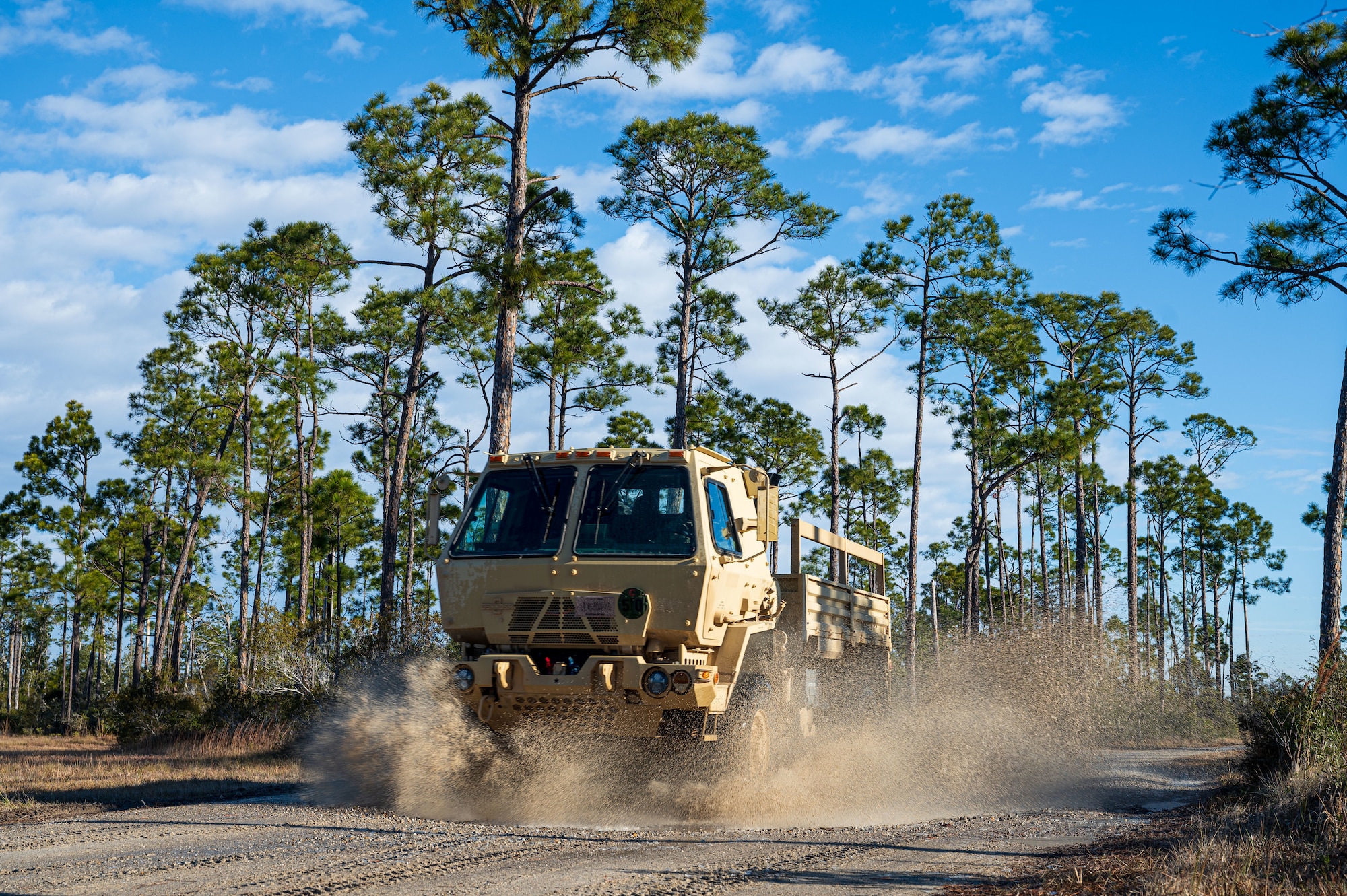 A U.S. Airman assigned to the 11th Air Task Force drives a light medium tactical vehicle to the convoy training site at Tyndall Air Force Base, Florida, Jan. 24, 2025. The training provided Airmen across various career fields experience driving large vehicles in different formations. (U.S. Air Force photo by Senior Airman Jasmyne Bridgers-Matos)