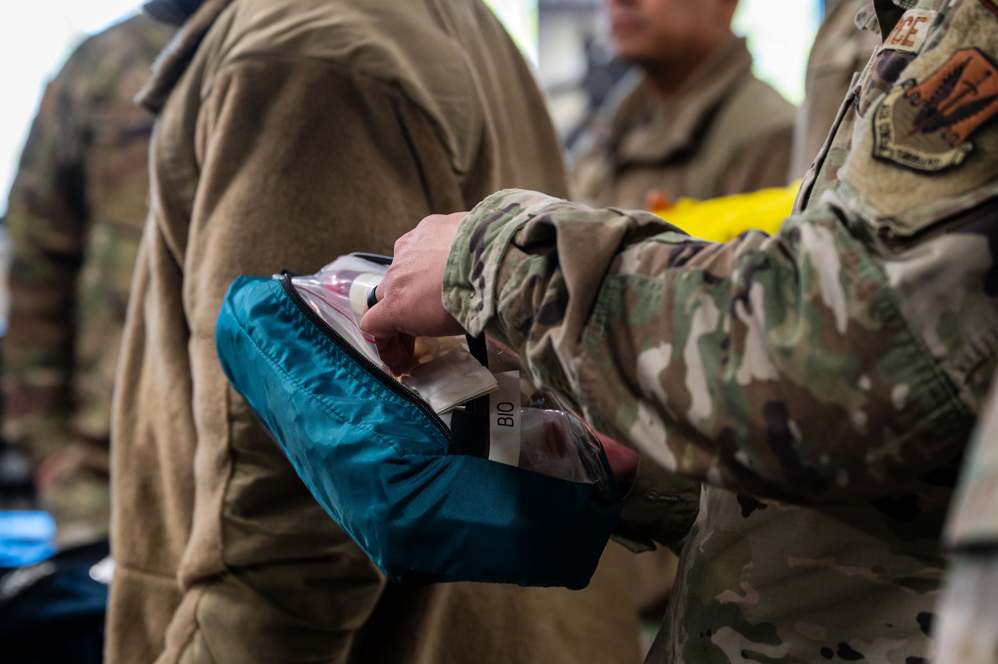 A U.S. Airman assigned to the 11th Air Task Force evaluates the contents of a chemical, biological, radiological and nuclear safety bag at Tyndall Air Force Base, Florida, Jan. 22, 2025. Airmen familiarized themselves with the tools they would be expected to use in the event of a CBRN attack. (U.S. Air Force photo by Senior Airman Jasmyne Bridgers-Matos)