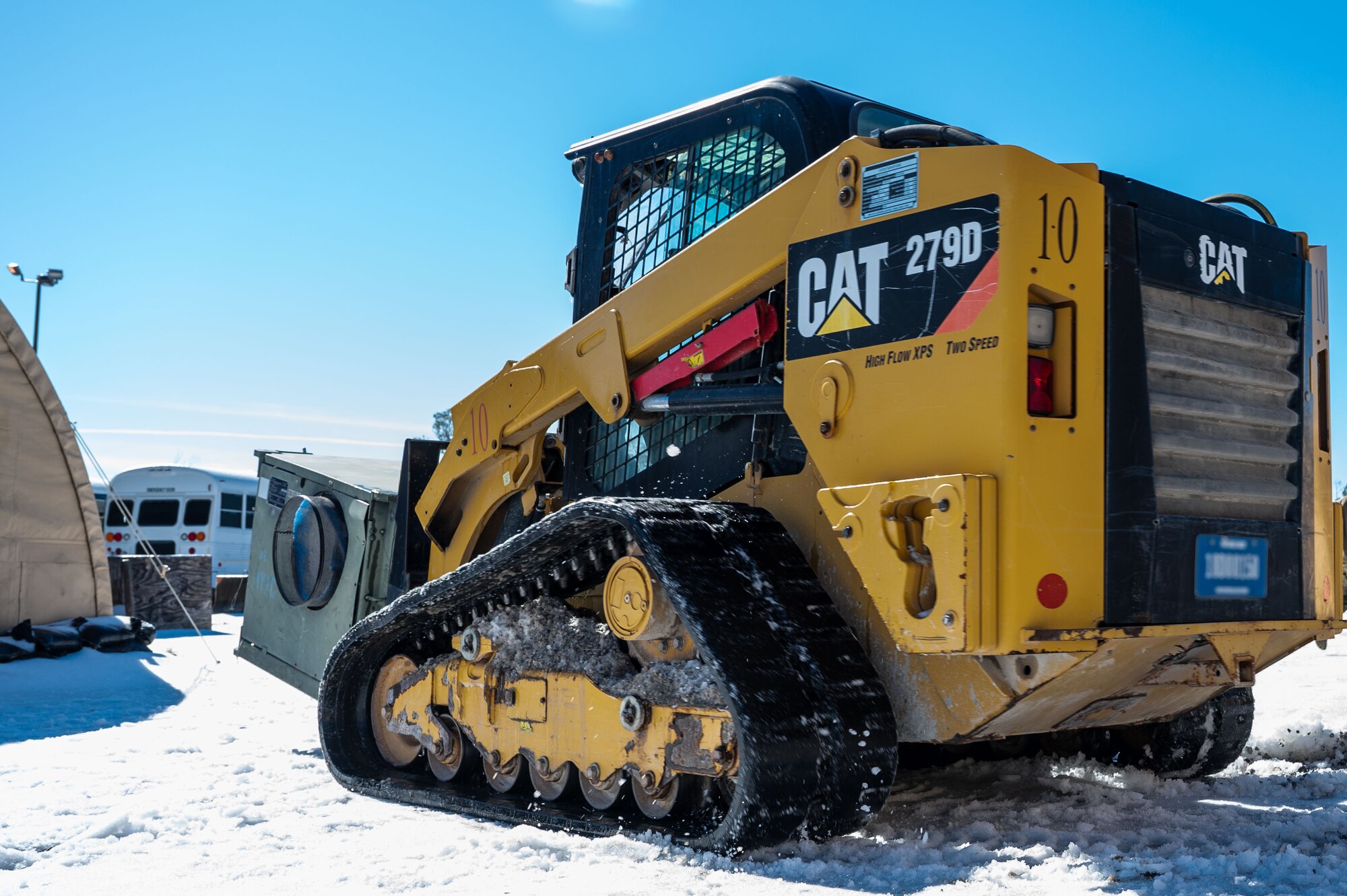 A U.S. Airman assigned to the 11th Air Task Force uses a compact track loader vehicle to transport a heating, ventilation and air conditioning unit at Tyndall Air Force Base, Florida, Jan. 22, 2025. Civil engineer Airmen maintained the infrastructure and utilities that support combat operations  . (U.S. Air Force photo by Senior Airman Jasmyne Bridgers-Matos)