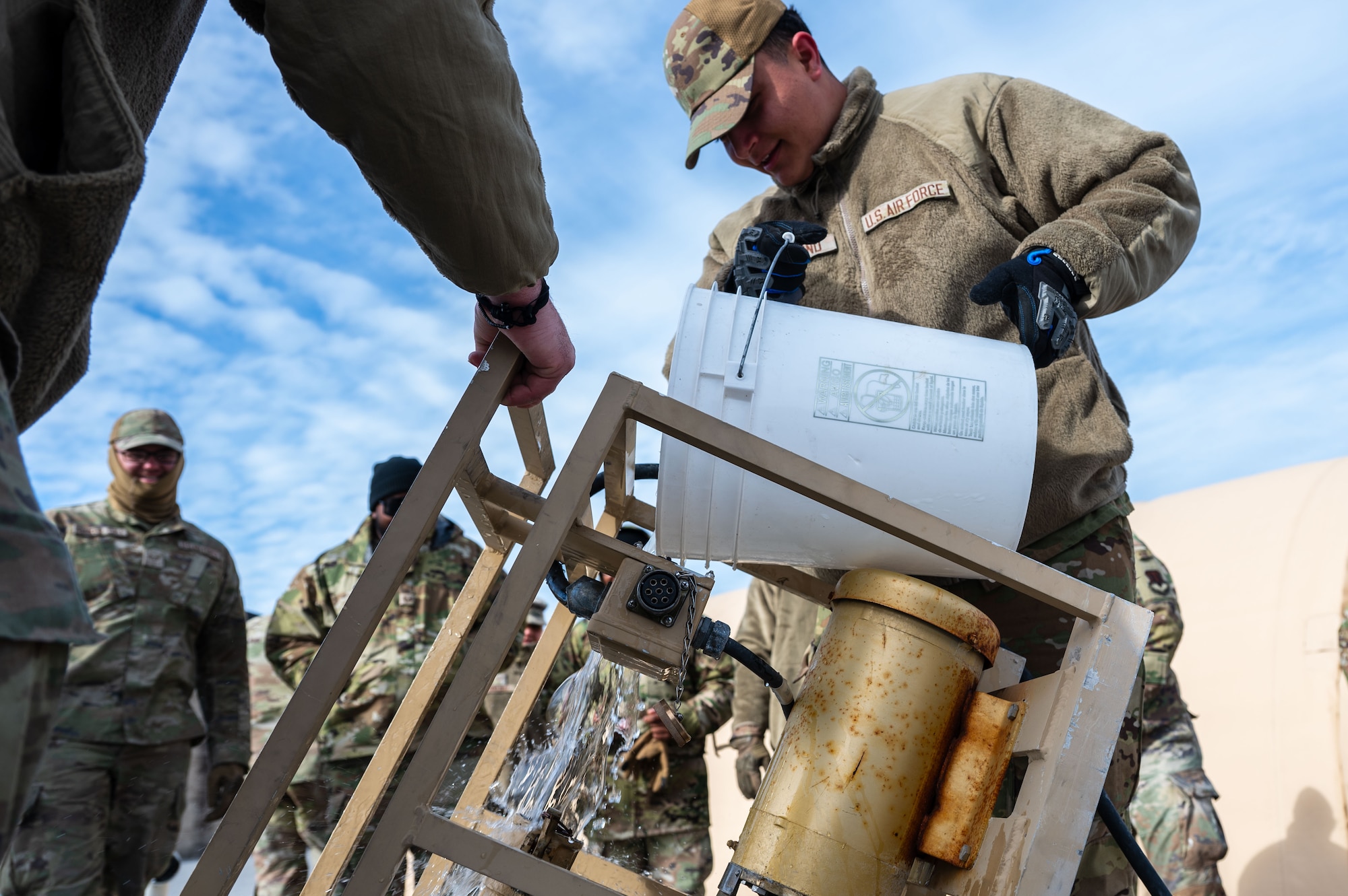 A U.S. Airman assigned to the 11th Air Task Force pours water to test its quality at Tyndall Air Force Base, Florida, Jan. 21, 2025. Tests ensured that the water was free from harmful substances. (U.S. Air Force photo by Senior Airman Jasmyne Bridgers-Matos)