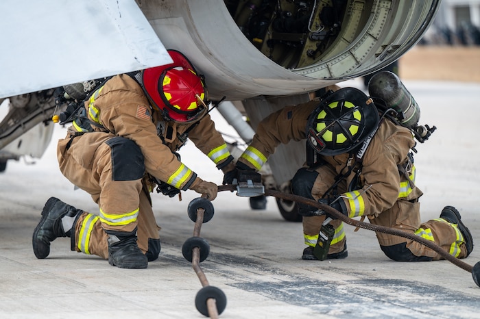 U.S. Airmen assigned to the 11th Air Task Force disconnect an aircraft arresting system from an F-16 Fighting Falcon aircraft at Tyndall Air Force Base, Florida, Jan. 27, 2025. The Airmen responded to an emergency aircraft landing following a simulated severe weather event. (U.S. Air Force photo by Senior Airman Jasmyne Bridgers-Matos)