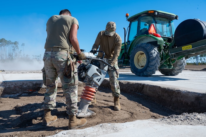 U.S. Airmen assigned to the 11th Air Task Force use a jumping jack on a damaged section of the flight line at Tyndall Air Force Base, Florida, Jan. 26, 2025. The jack was used to compact the dirt before the Airmen added a protective layer. (U.S. Air Force photo by Senior Airman Jasmyne Bridgers-Matos)