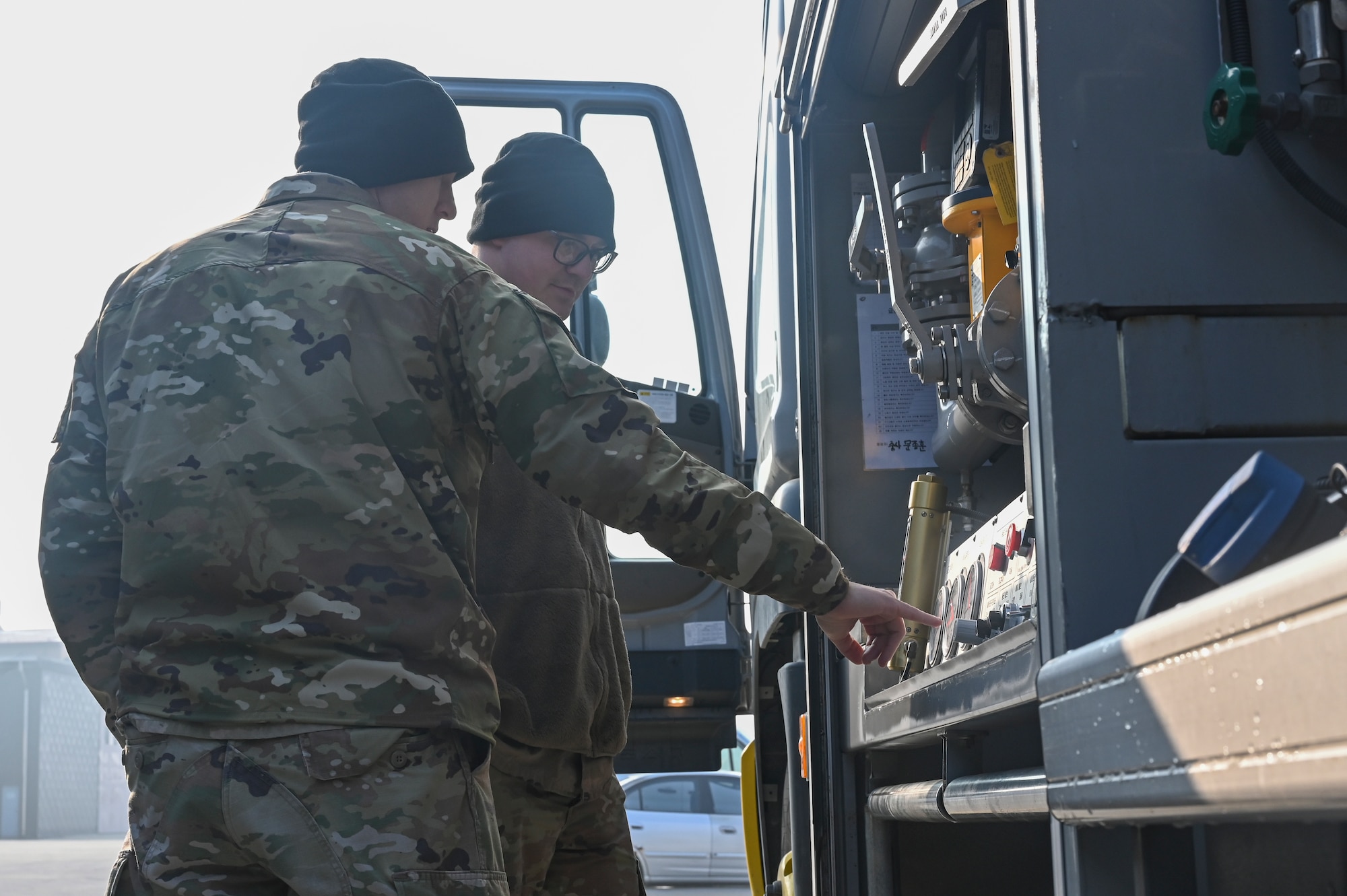 U.S. Air Force Tech. Sgt. Jonathan Franks, left, 8th Logistics Readiness Squadron NCO in charge of fuels distribution and Tech. Sgt. Brandon Craver, 8th LRS fuels training support craftsman, inspect a new Republic of Korea Air Force aircraft refueling unit feature.