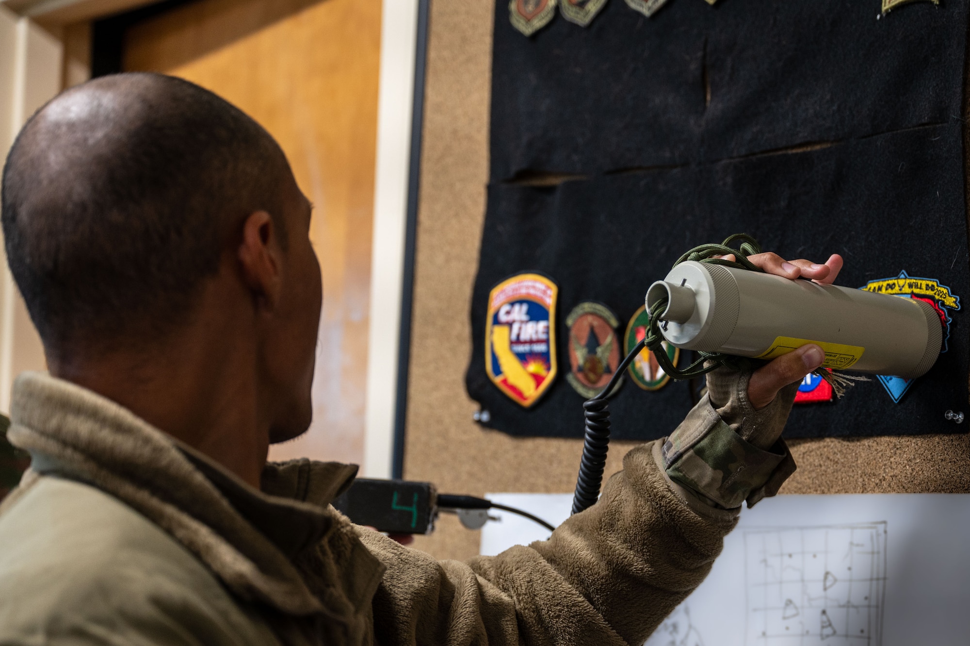 A U.S. Airman assigned to the 11th Air Task Force uses a radiological detection system to locate traces of radiation at Tyndall Air Force Base, Florida, Jan. 22, 2025. Airmen were trained on personal safety and detection measures when encountering chemical, biological, radiological and nuclear material. (U.S. Air Force photo by Senior Airman Jasmyne Bridgers-Matos)