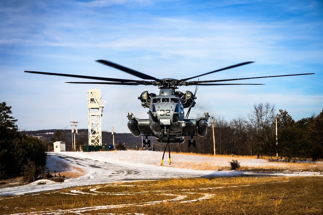 A CH-53E Super Stallion helicopter assigned to Marine Heavy Helicopter Squadron 772 lifts off at Fort Indiantown Gap, P.A., Jan. 22, 2025. The helicopter was requested on behalf of the Pennsylvania Army National Guard to lift and relocate nine Stryker armored vehicles to the Fort Indiantown Gap training range. The lift was assisted by a team of U.S. Air Force Airmen assigned to the 621st Contingency Response Group who secured and released each Stryker to the helicopter. (U.S. Air Force photo by Senior Airman Matt Porter)