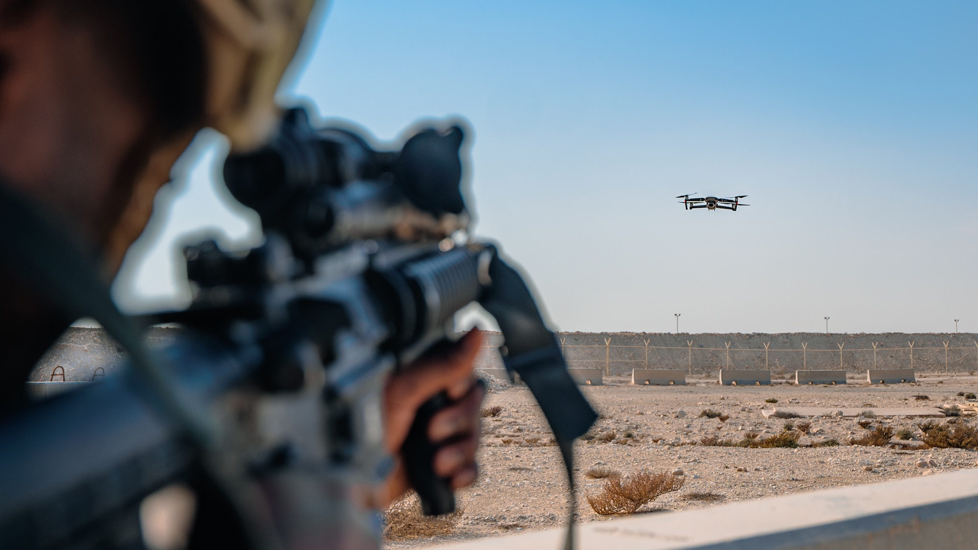Airman aims rifle at drone