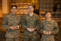 From left to right, U.S. Marine Corps Cpl. Raymond Brito, a network administrator; Lance Cpl. Ethan Stump, a combat engineer; and Pfc. Hayden Miller, an intelligence specialist, all with Combat Logistics Regiment 37, 3rd Marine Logistics Group, pose for a group photo following recognition from Brig. Gen. Kevin Collins, the commanding general of 3rd MLG, at the conclusion of GATOREX on Camp Kinser, Okinawa, Japan, Jan. 17, 2025. GATOREX is an exercise that simulates logistical operations in a combat scenario, focusing on the unit’s response to adversarial threats with an emphasis on resource management and coordination across the force. (U.S. Marine Corps photo by Cpl. Jonathan Rodriguez Pastrana)