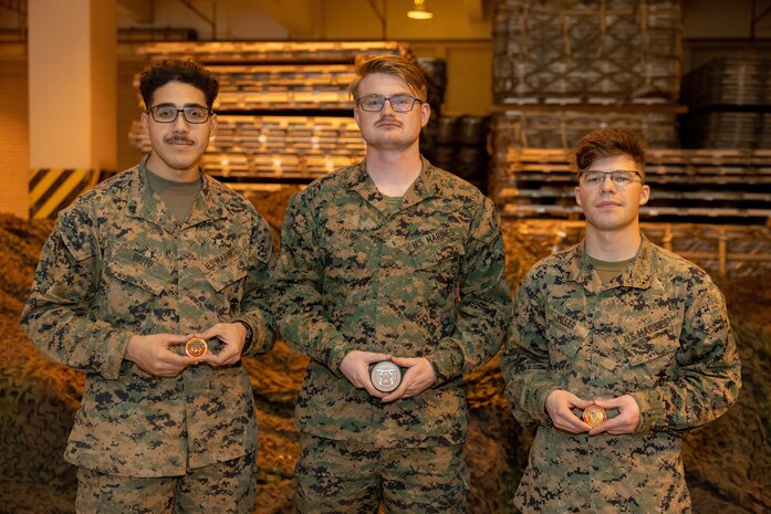 From left to right, U.S. Marine Corps Cpl. Raymond Brito, a network administrator; Lance Cpl. Ethan Stump, a combat engineer; and Pfc. Hayden Miller, an intelligence specialist, all with Combat Logistics Regiment 37, 3rd Marine Logistics Group, pose for a group photo following recognition from Brig. Gen. Kevin Collins, the commanding general of 3rd MLG, at the conclusion of GATOREX on Camp Kinser, Okinawa, Japan, Jan. 17, 2025. GATOREX is an exercise that simulates logistical operations in a combat scenario, focusing on the unit’s response to adversarial threats with an emphasis on resource management and coordination across the force. (U.S. Marine Corps photo by Cpl. Jonathan Rodriguez Pastrana)