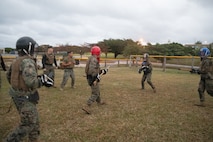 U.S. Marines with III Marine Expeditionary Force, weapon spar during a Martial Arts Instructor course culminating event on Camp Kinser, Okinawa, Japan, Jan. 27, 2025.  Marines across III MEF commands attended this MAI course to develop the skills, knowledge, and resiliency required to instruct and certify Marines through the Marine Corps Martial Arts Program, enhancing the combat effectiveness and physical readiness of their unit. (U.S. Marine Corps photo by Lance Cpl. Thomas Vu)
