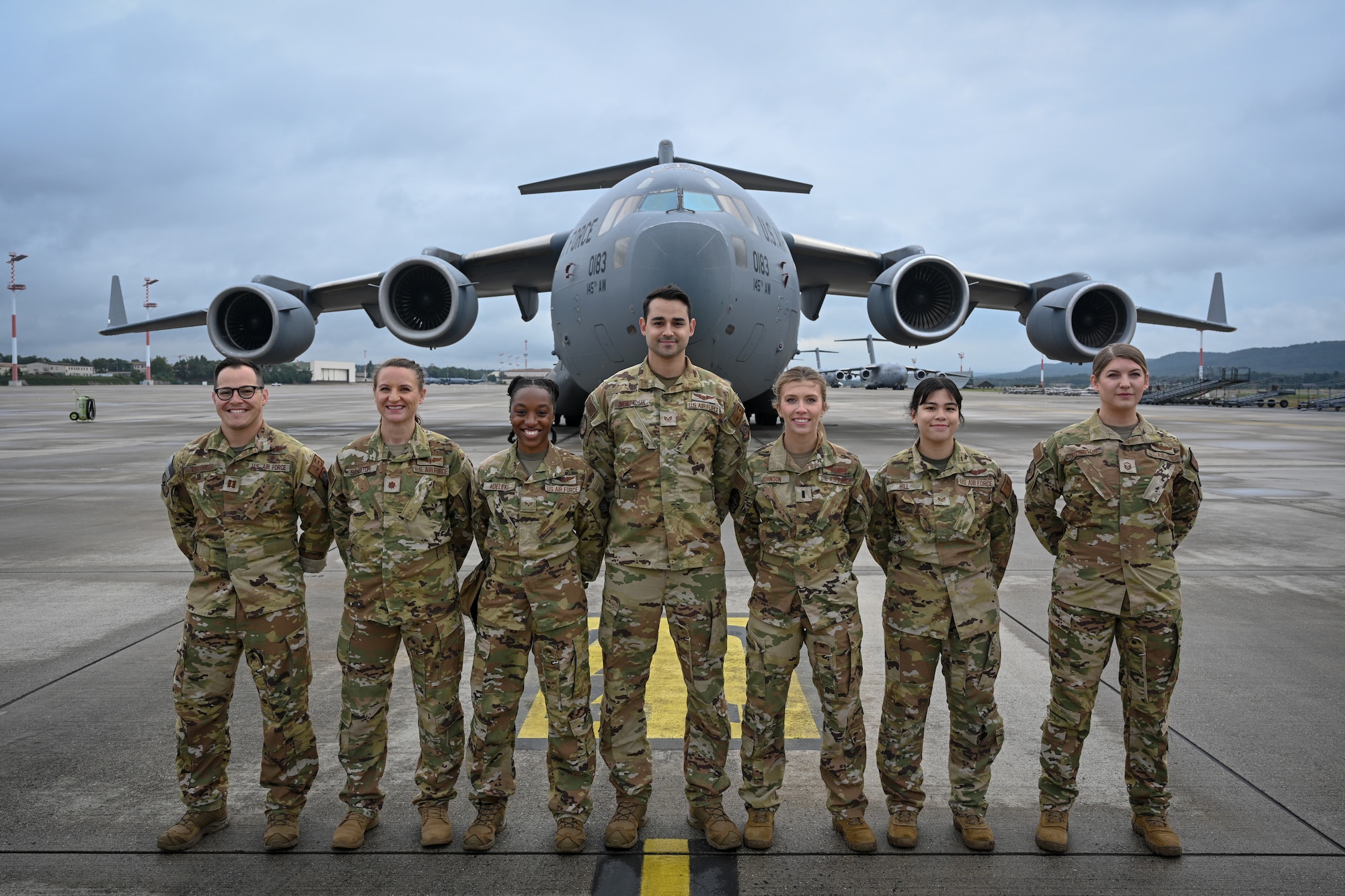 Staff Sgt. Alexis Adeleke, 36th Aeromedical Evacuation Squadron flight medical technician, stands with an AE team during her deployment