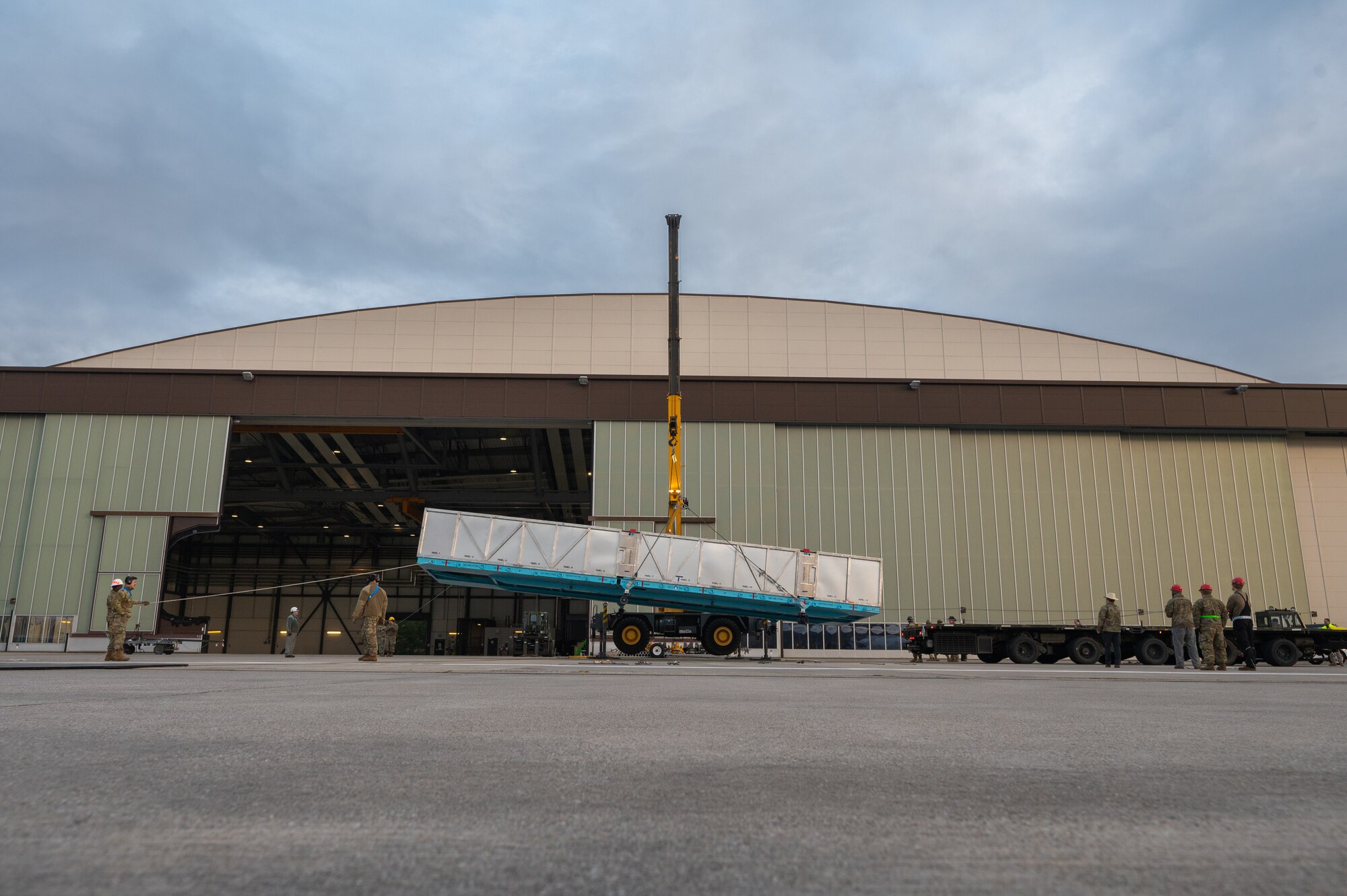 Airmen lower a crate