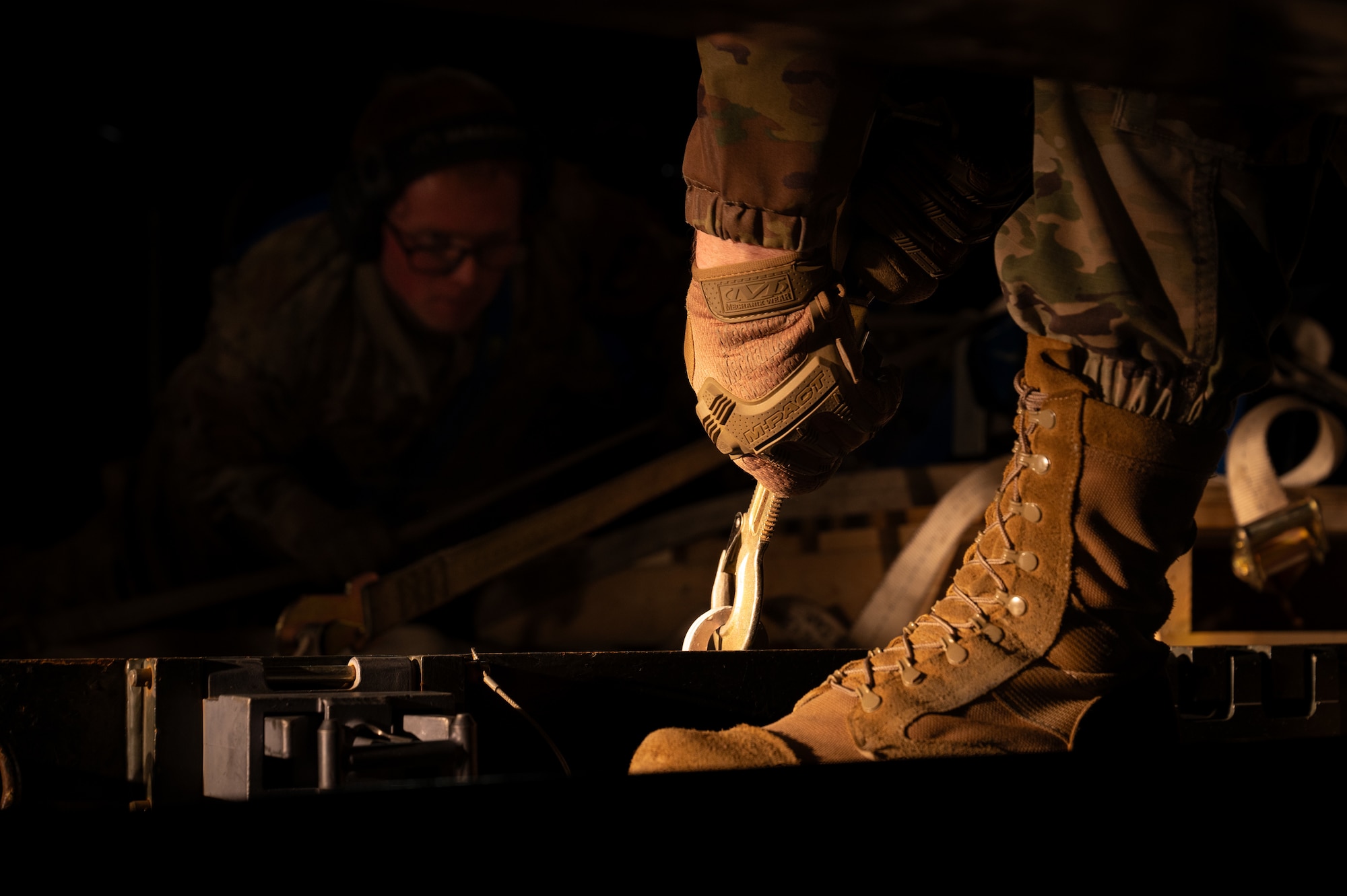 Two men offload an aircraft wing
