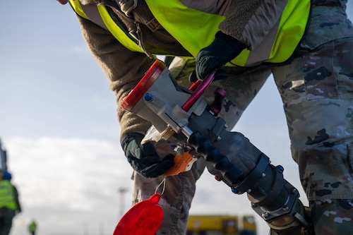 U.S. Airman holding hose for hot pit refueling
