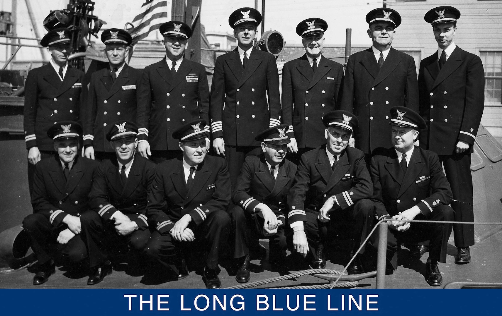 A photograph of Hart (in back row) posing with a group of Coast Guard officers on the deck of an 83-foot patrol boat. (U.S. Coast Guard)