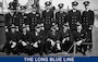 A photograph of Hart (in back row) posing with a group of Coast Guard officers on the deck of an 83-foot patrol boat. (U.S. Coast Guard)