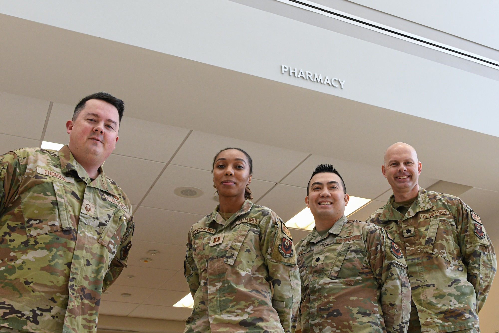 Air Force Lt. Col. Michael Oetjens, 27th Special Operations Health Care Operations Squadron commander (right), Lt. Col. Sang Ngo, 27th SOHCOS diagnostic and therapeutics flight commander, Capt. Modesta Ugochukwu, 27th SOHCOS chief of pharmacy operations, and Master Sgt. Robert Thomas, 27th SOHCOS diagnostic and therapeutics flight chief, pose for a photograph at Cannon Air Force Base, New Mexico, Jan. 14, 2025. Improving medical care access for Airmen and families is a top priority for the 27th Special Operations Wing. (U.S. Air Force photo by Senior Airman Drew Cyburt)