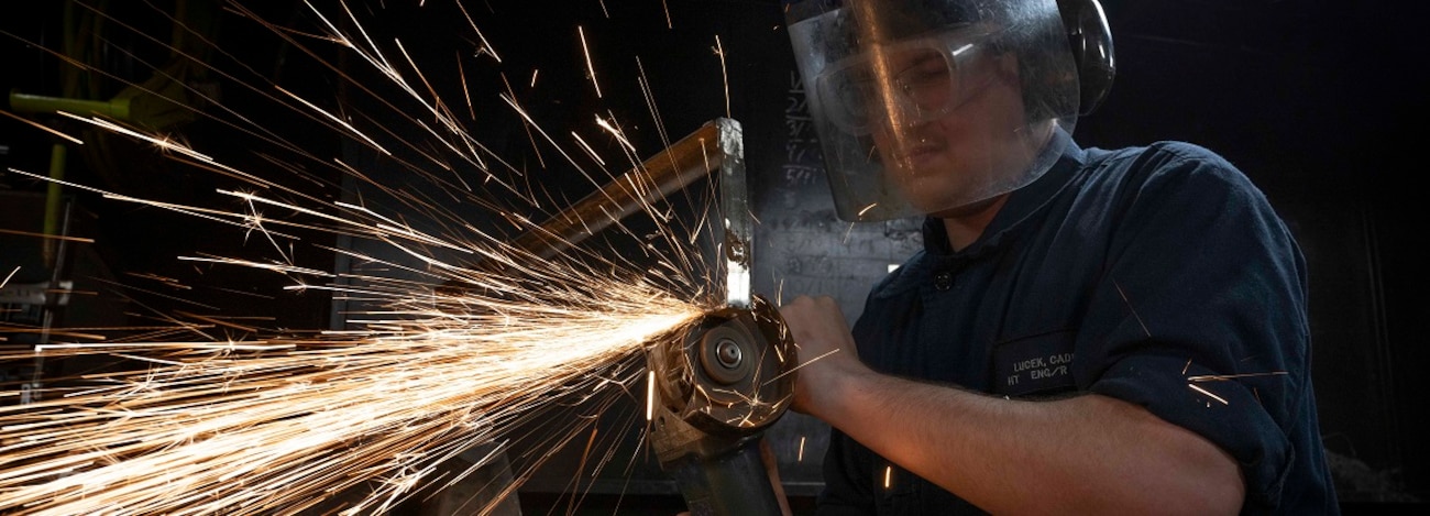 Hull Maintenance Technician Fireman Caden Lucek, from Cottage Grove, Oregon, grinds scrap metal aboard the aircraft carrier USS Nimitz (CVN 68) in the Pacific Ocean, Jan. 27, 2025.