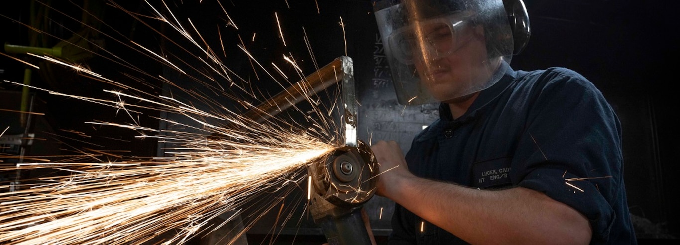 Hull Maintenance Technician Fireman Caden Lucek, from Cottage Grove, Oregon, grinds scrap metal aboard the aircraft carrier USS Nimitz (CVN 68) in the Pacific Ocean, Jan. 27, 2025.