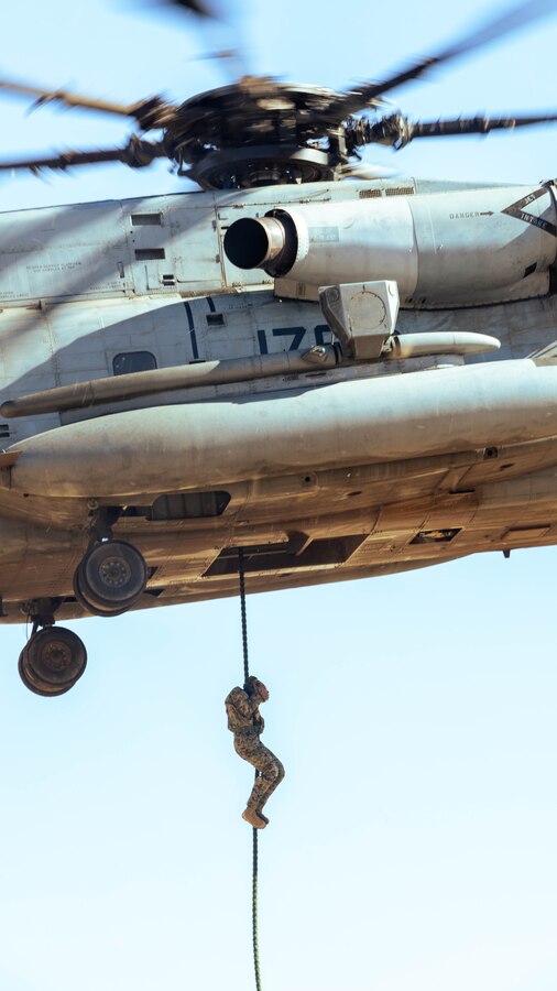 A U.S. Marine with 1st Marine Division fast ropes from a CH-53E Super Stallion during a fast rope course hosted by Special Training Branch, Expeditionary Operations Training Group, I Marine Expeditionary Force, at Marine Corps Base Camp Pendleton, California, Jan. 15, 2025. EOTG trains deploying units in individual and collective tasks and evaluates their ability to conduct mission essential tasks to prepare those forces to support geographic combatant commanders. (U.S. Marine Corps photo by Cpl. Brian Knowles)
