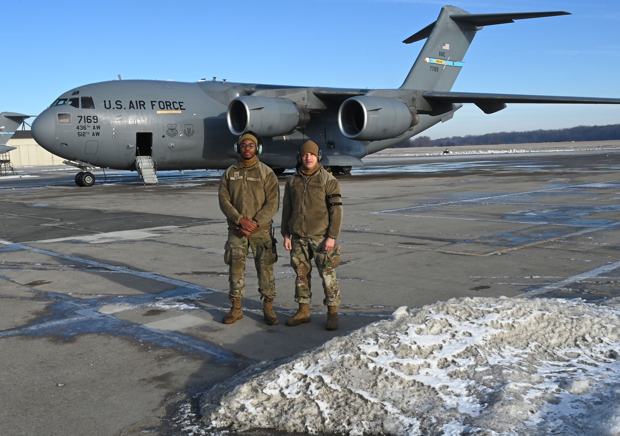 Maintainers stand in front of aircraft