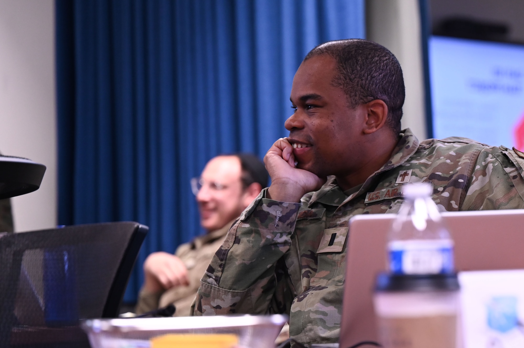 U.S. Air Force 1st Lt. Henckel Miranda, 102nd Intelligence Wing chaplain smiles during a team project presentation on the Department of the Air Force Instruction at Maxwell Air Force Base, Alabama, Jan. 28, 2025.