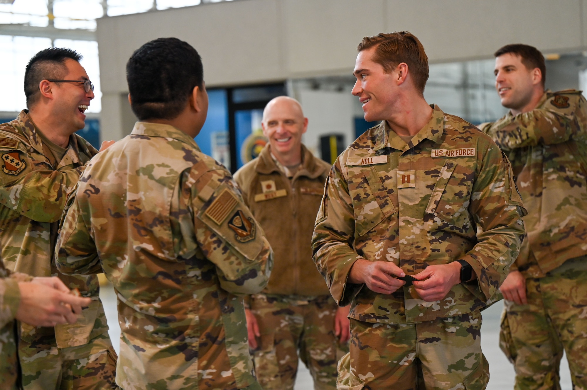 U.S. Airmen interact with each other after receiving base honor guard patches during a training in Military Funeral Honor protocols at Maxwell Air Force Base, Alabama, Jan. 27, 2025.