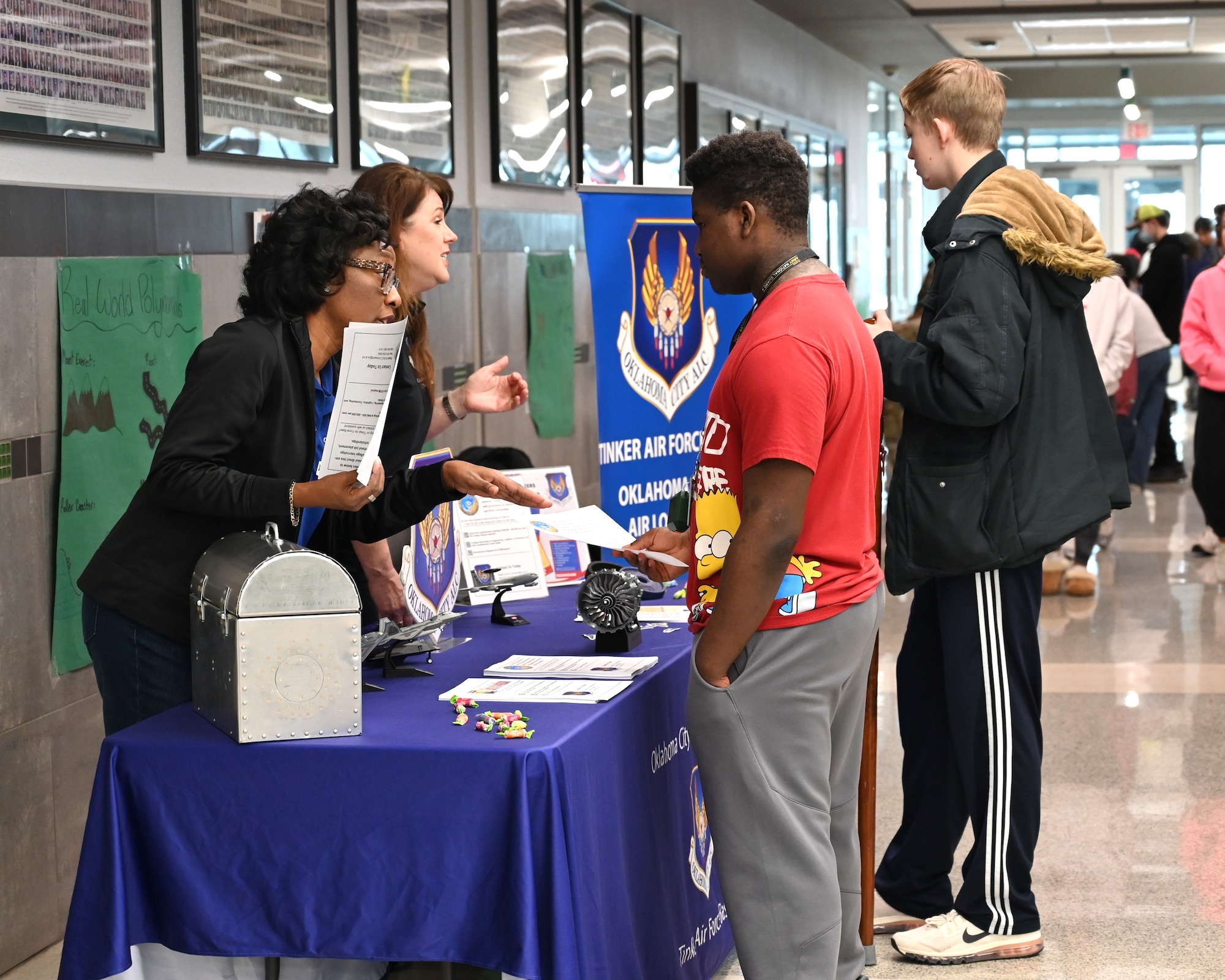 two women speaking to two male students